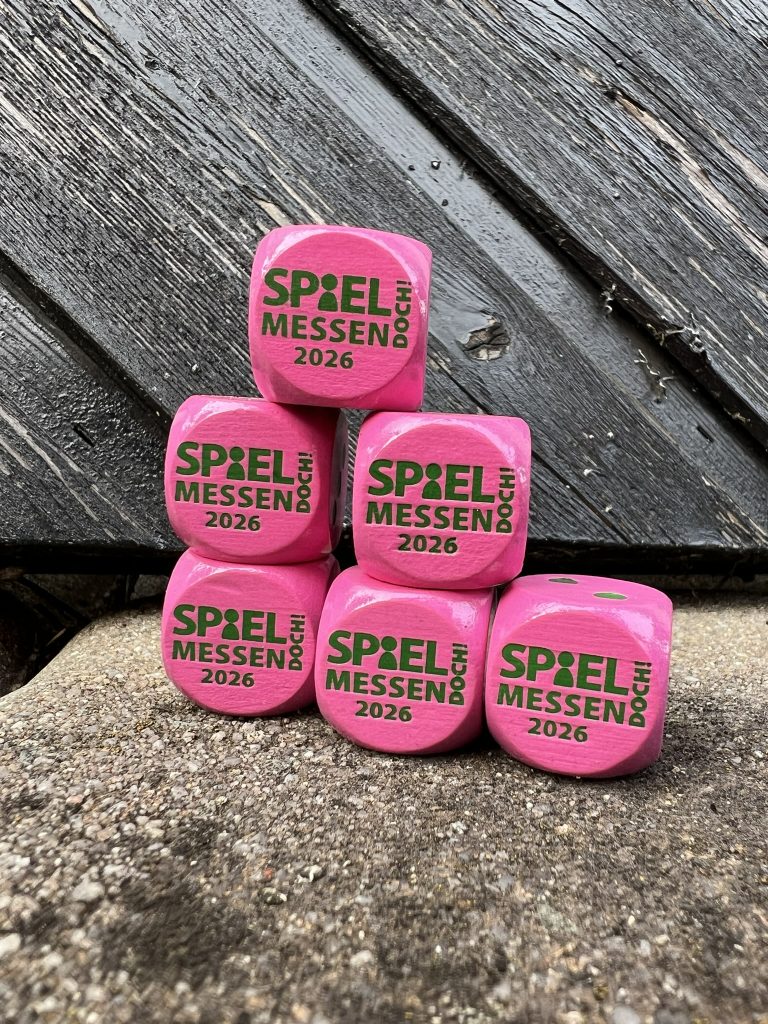 pinke Messewürfel von 2026 mit grüner Schrift